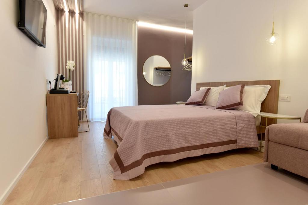 a bedroom with a bed and a table and a couch at Dimora Al Castello in Matera