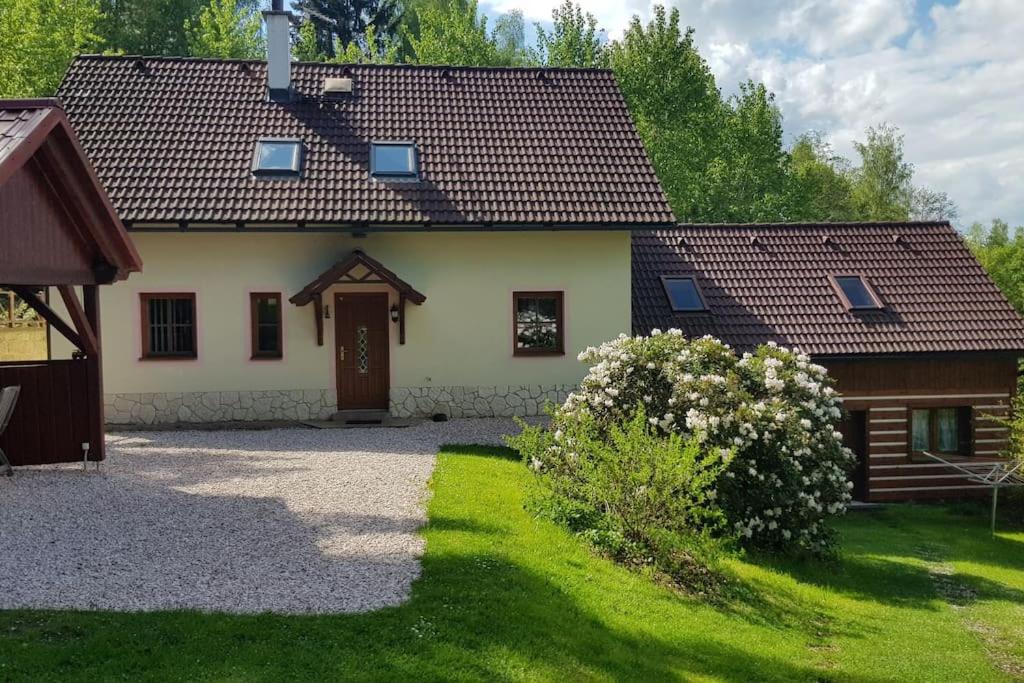 ein Haus mit einem grünen Garten davor in der Unterkunft Elitní wellness penzion U Dvou jedlí v srdci Českého ráje in Turnov