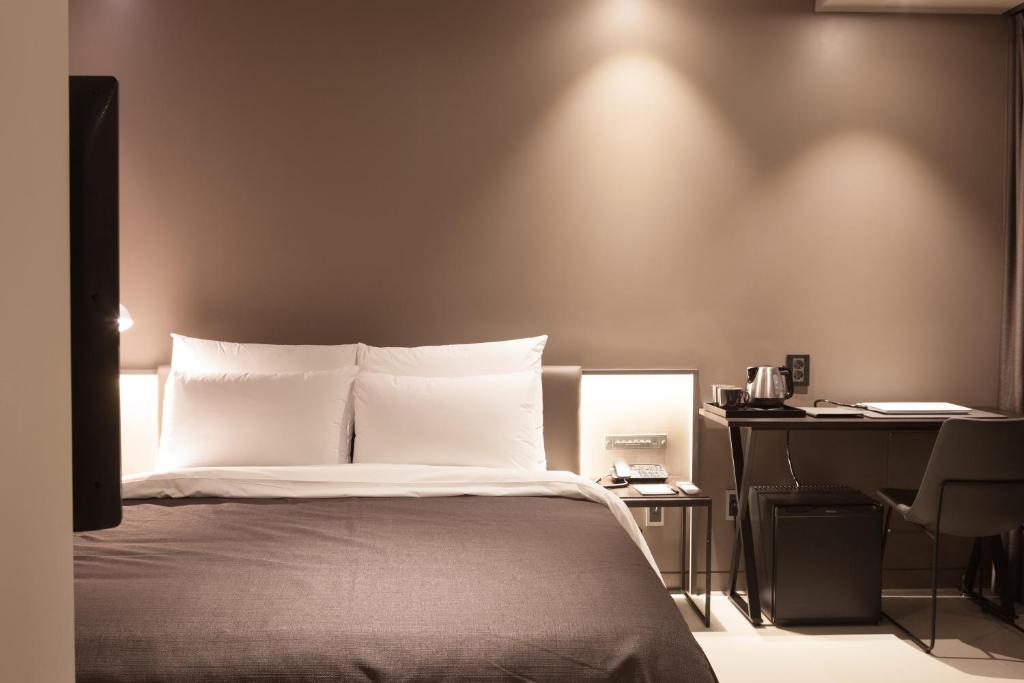 Postel nebo postele na pokoji v ubytování Hotel Gaden
