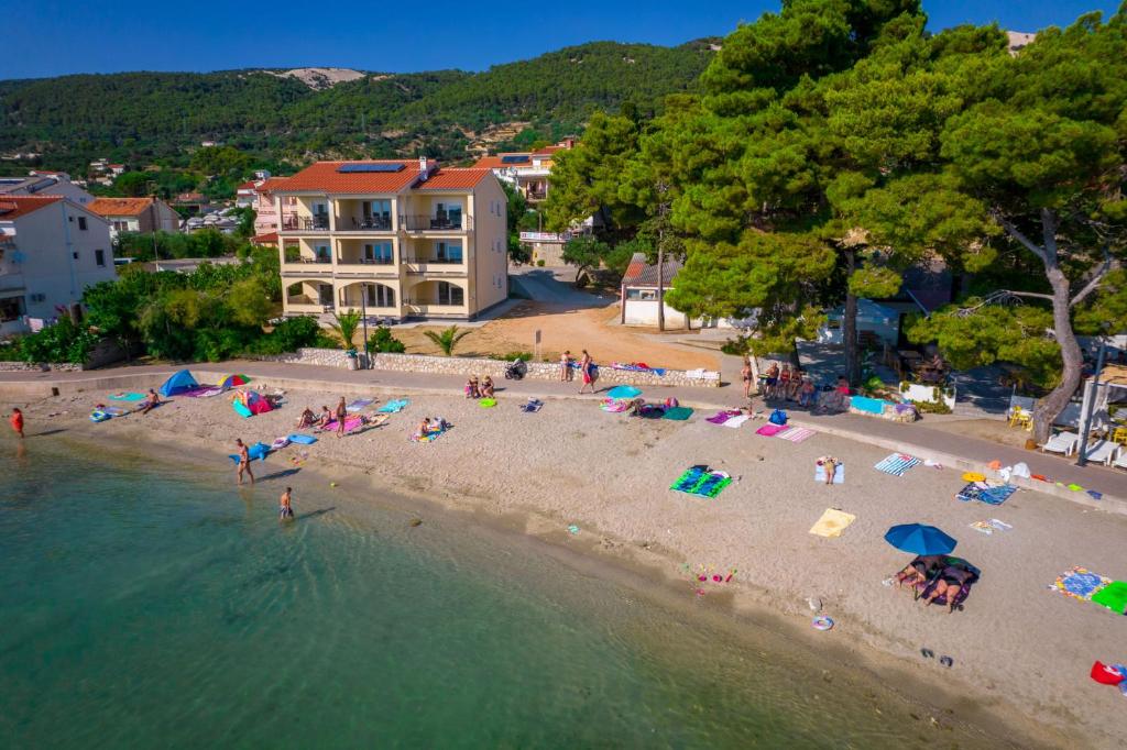 an aerial view of a beach with people in the water at Apartments Villa Alba in Banjol
