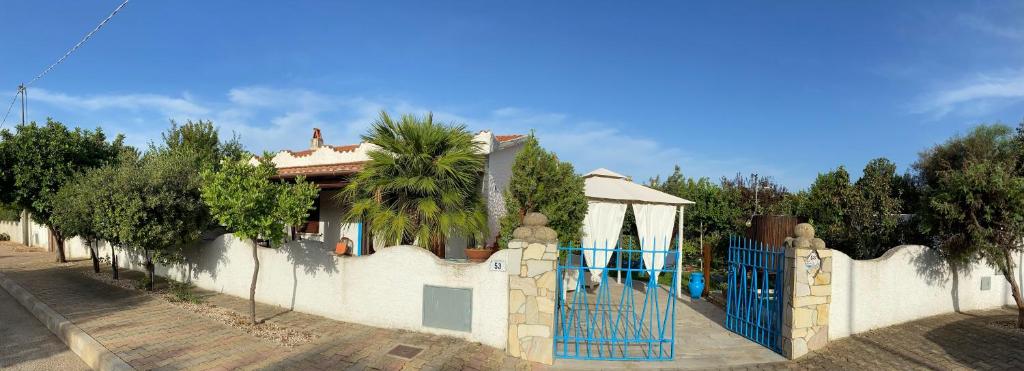 una casa con una puerta azul y una palmera en Villa Gino, en Santa Lucia