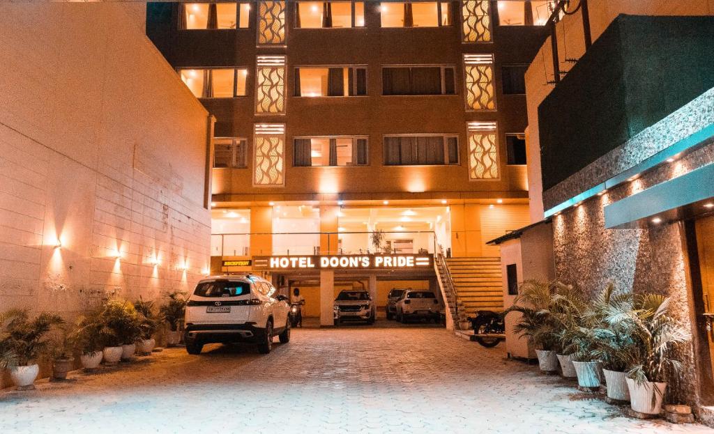 a car parked in front of a building at Hotel Doon's Pride in Dehradun