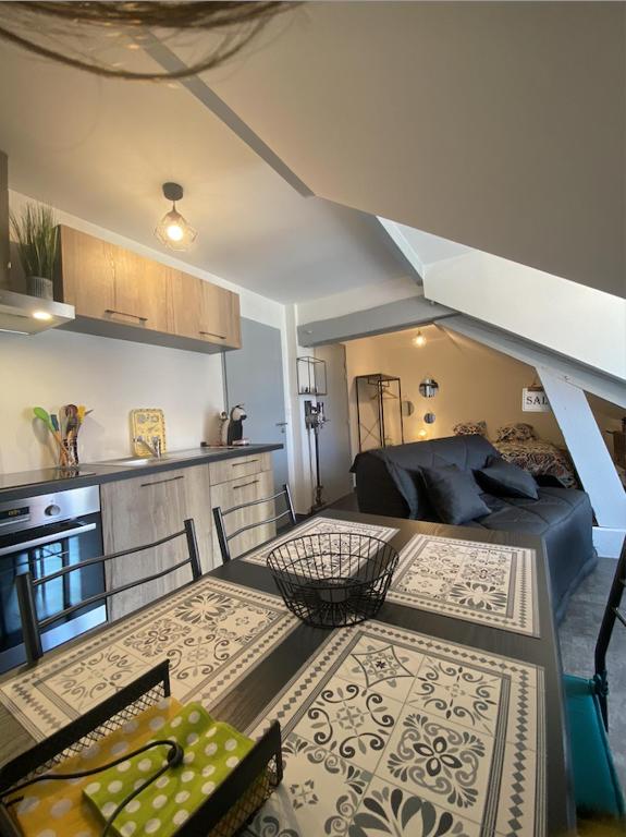 a living room with a couch and a table at Le Grenier Saint-Pierre in Verdun