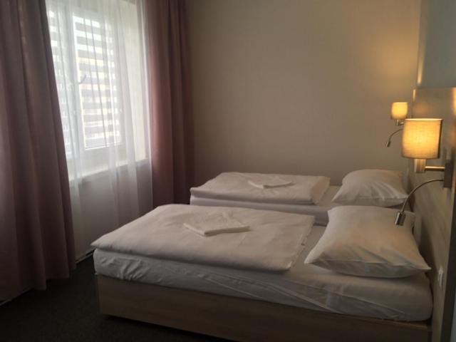 Postel nebo postele na pokoji v ubytování Hotel Trim