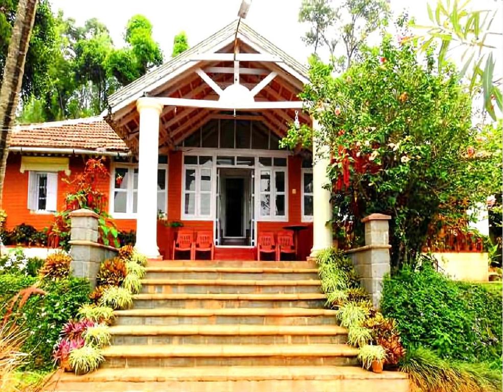 a house with stairs leading to the front door at Athithi Homestay by StayApart in Avathi