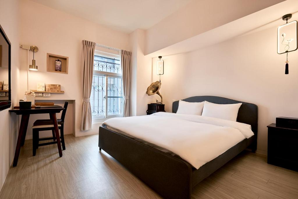 Postel nebo postele na pokoji v ubytování 安蘭居旅店 An Lan Jie Hotel