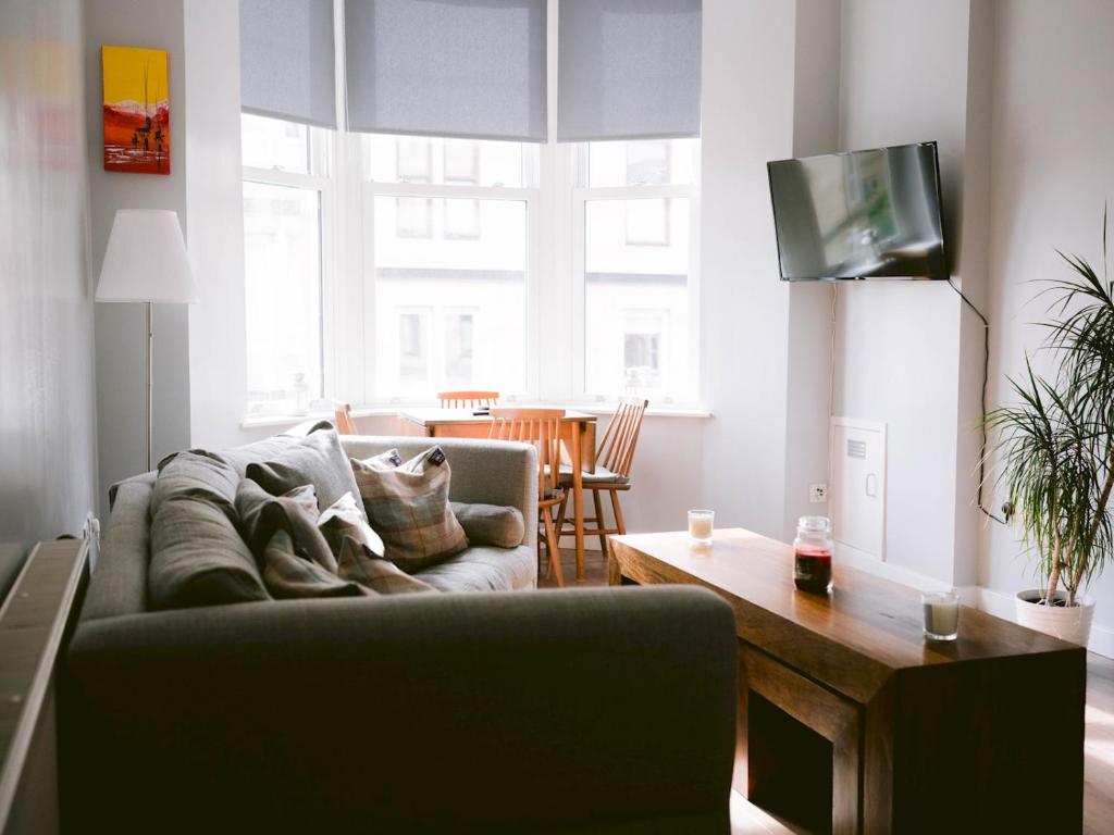 a living room with a couch and a table at Pass the Keys Lovely Traditional 2 Bedroom Flat in West End in Glasgow