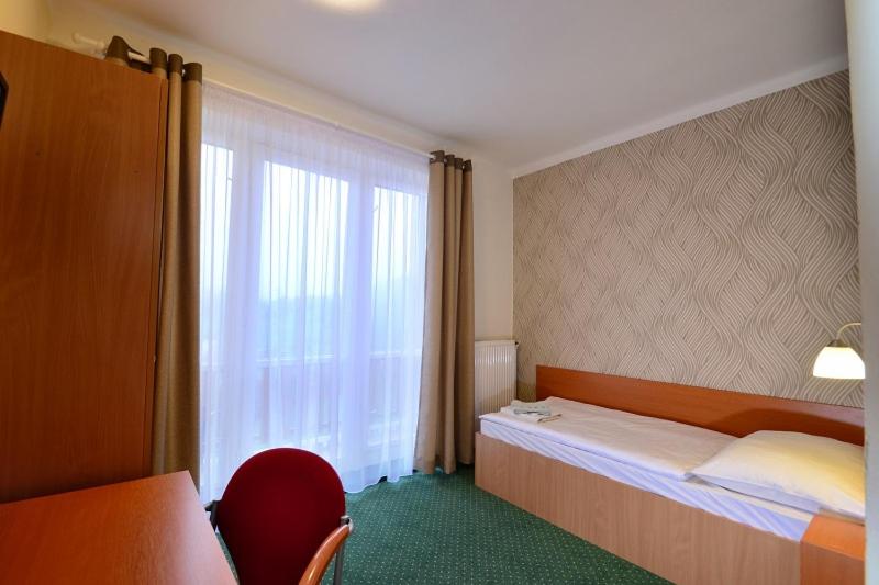 Postel nebo postele na pokoji v ubytování Wellness Penzion Kotár