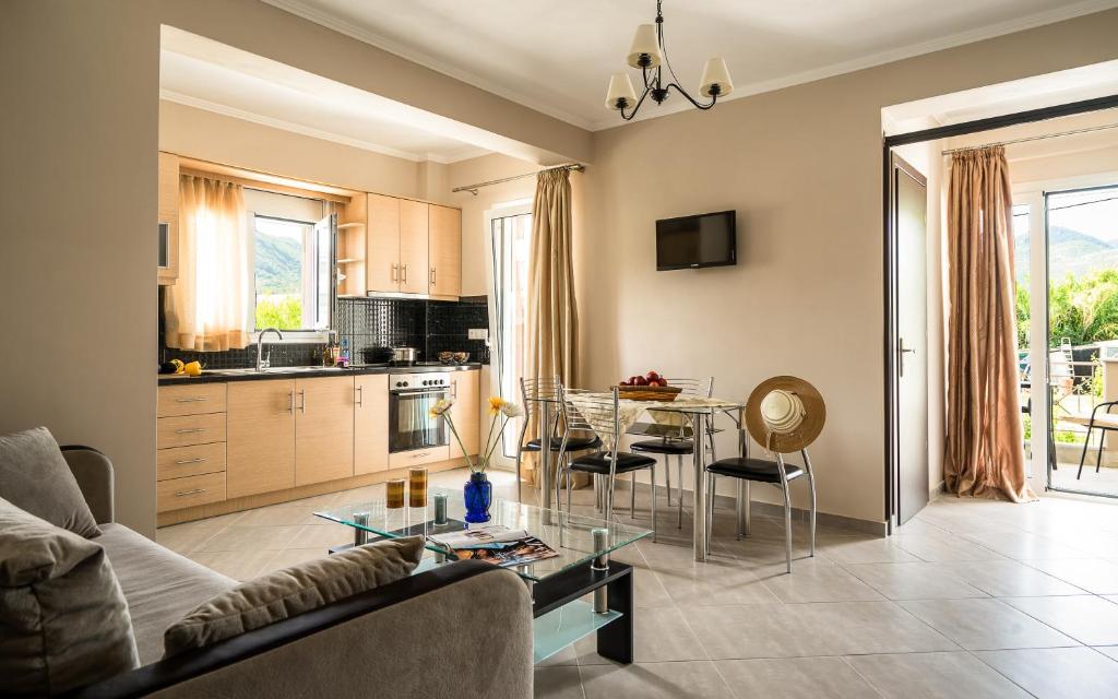 a living room with a couch and a table at Emily Apartments in Nydri