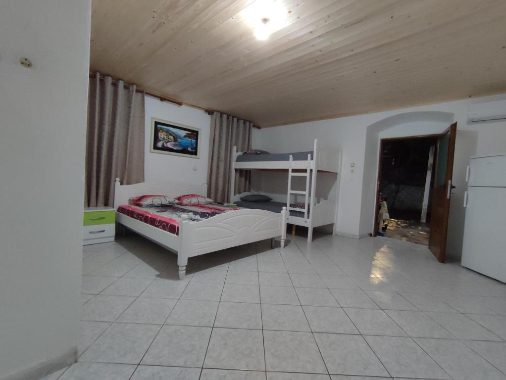 a bedroom with a bed and a bunk bed at Summer room in Himare