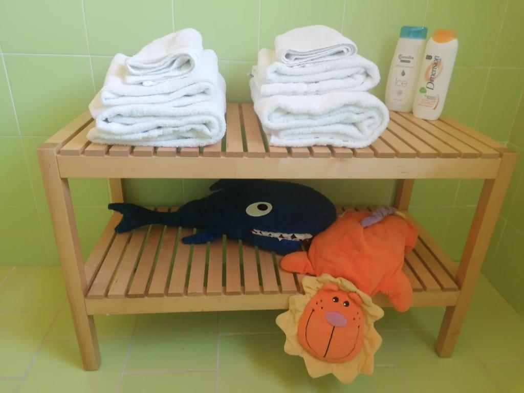 a shelf with towels and a stuffed animal on it at Agriturismo Sentiero delle Fiabe in Sirolo