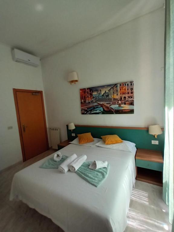 Postel nebo postele na pokoji v ubytování Hotel Castelfidardo