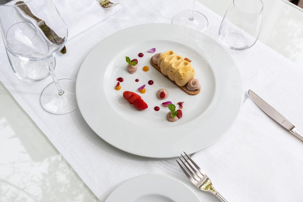 a white plate with food on a table at Carrick Hotel Camogli Portofino Coast in Camogli