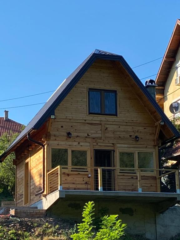 a log cabin with a gambrel roof at Apartman Lenka in Mokra Gora