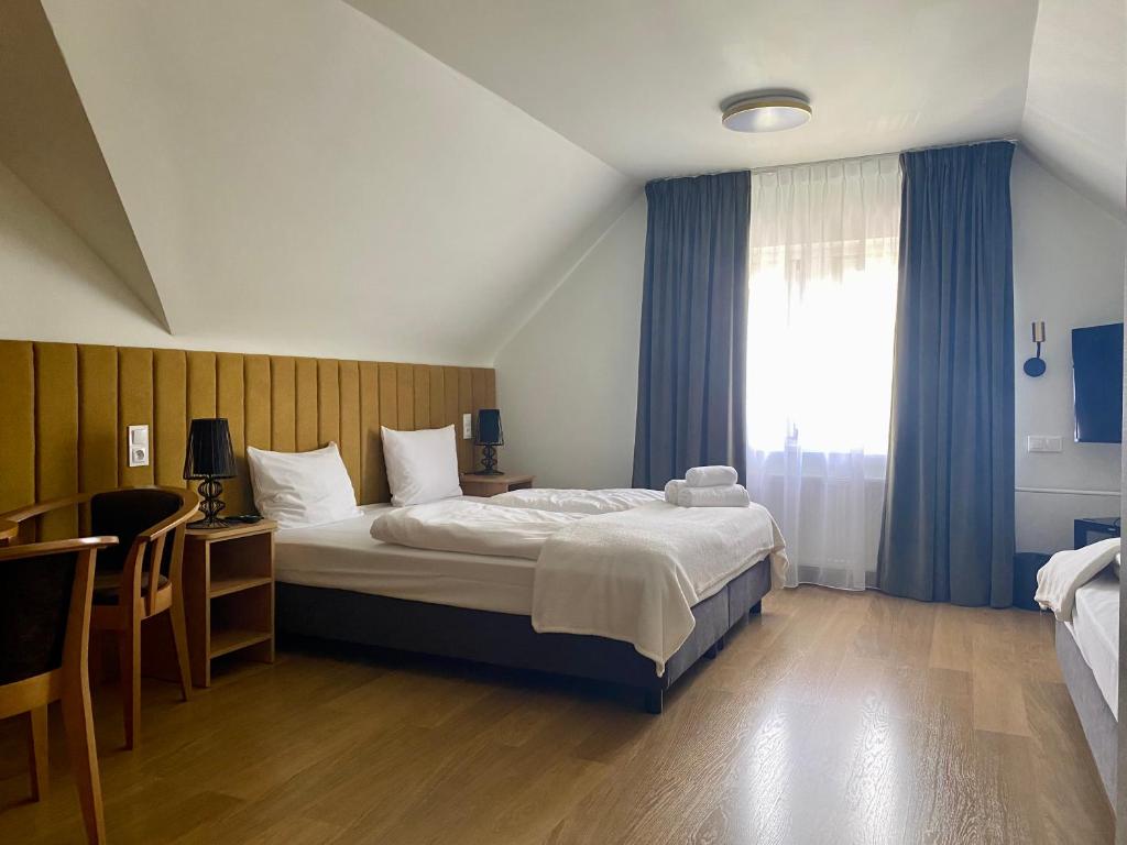 A bed or beds in a room at Perła Sudetów by Stay inn Hotels