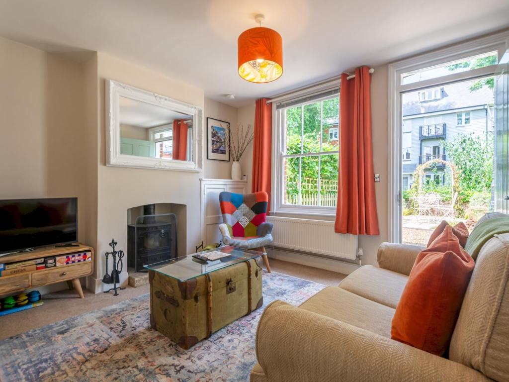 a living room with a couch and a tv at Pass the Keys Charming 2 bed cottage with parking in Canterbury in Canterbury