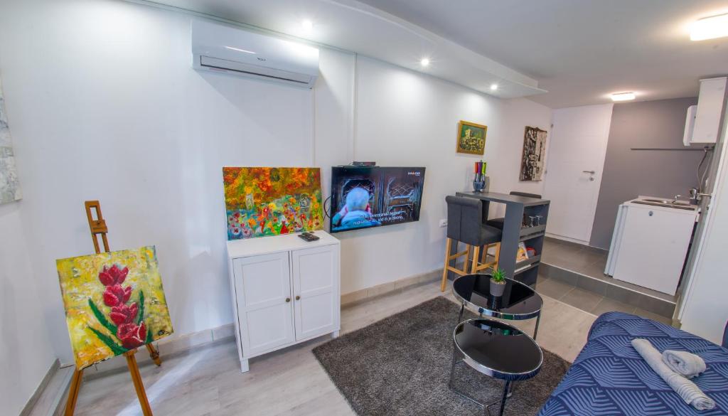 a living room with a painting on the wall at Studio Gallery in Mostar