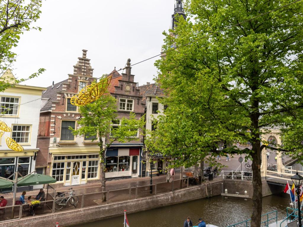 a city street filled with lots of trees and buildings at Wolf Hotel Kitchen & Bar in Alkmaar