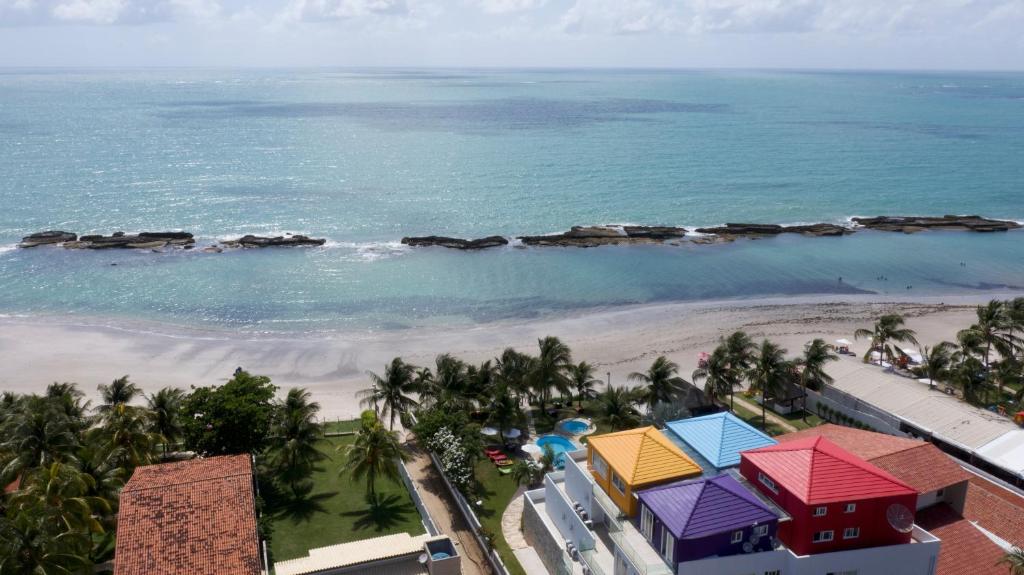 an aerial view of the beach at the paradiso resort at As Coloridas in Praia dos Carneiros