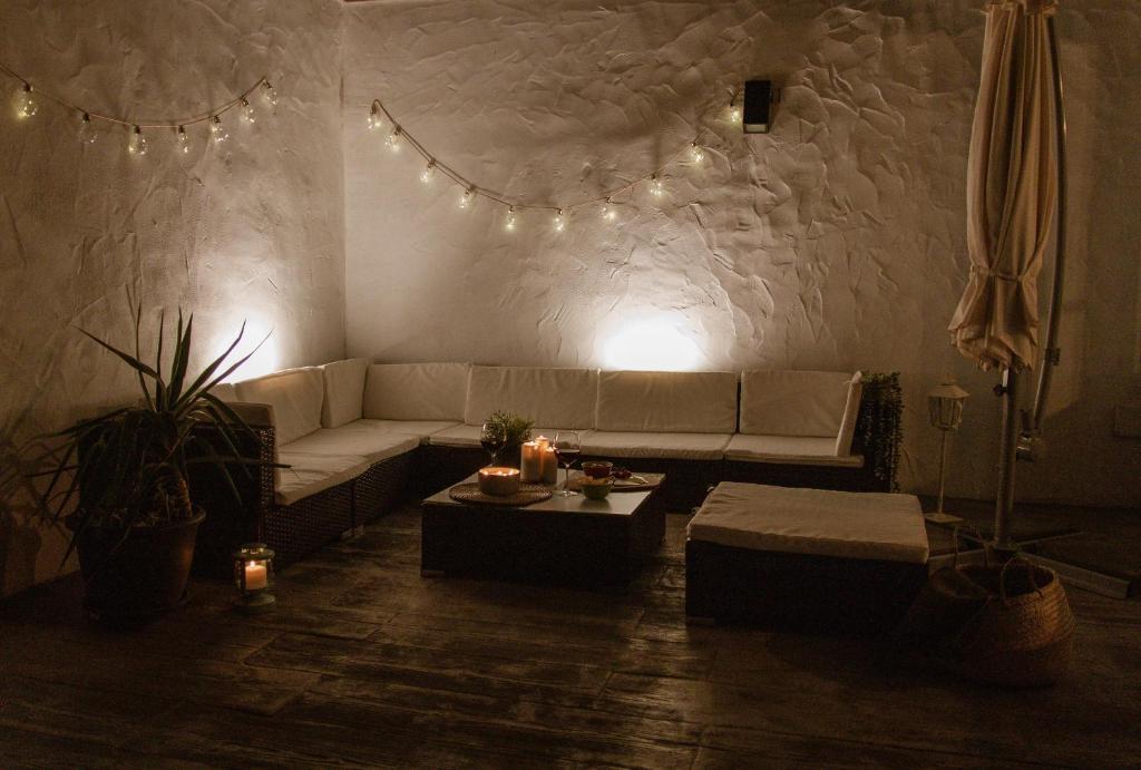 a living room with a couch and a table and lights at El Retiro de la Adrada AVILA in La Adrada