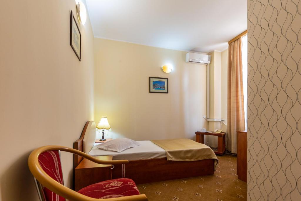 Postel nebo postele na pokoji v ubytování Hotel Amphitryon