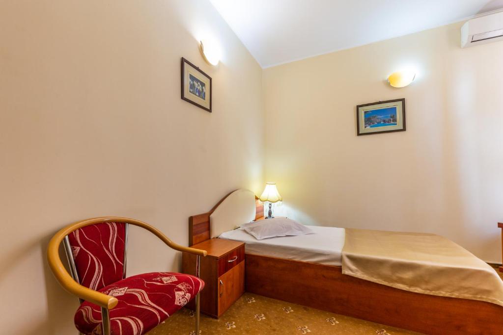 Postel nebo postele na pokoji v ubytování Hotel Amphitryon