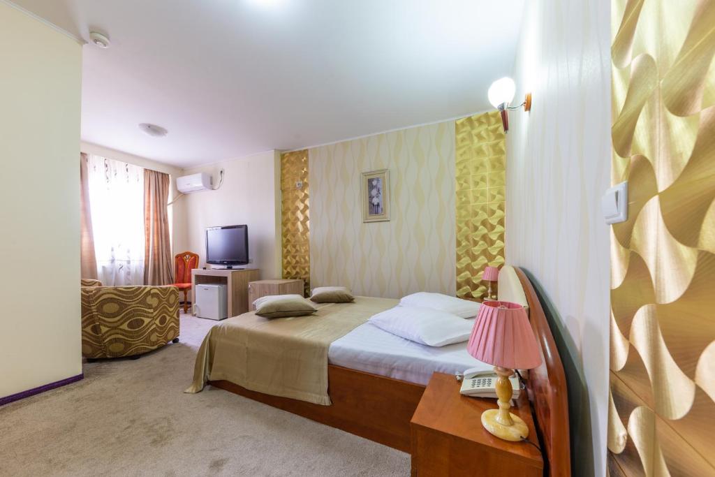 Postel nebo postele na pokoji v ubytování Hotel Amphitryon