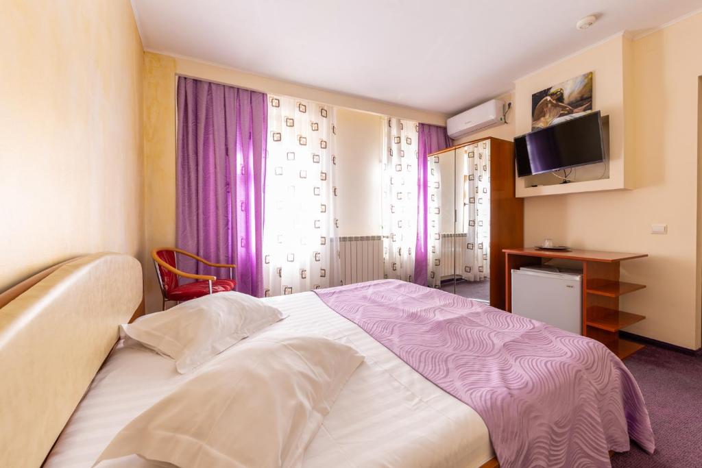 Postel nebo postele na pokoji v ubytování Hotel Amphitryon