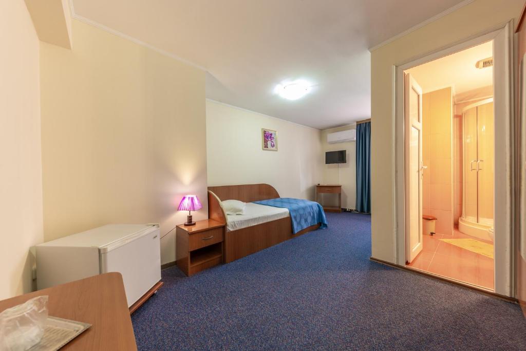Postel nebo postele na pokoji v ubytování Hotel Amphitryon