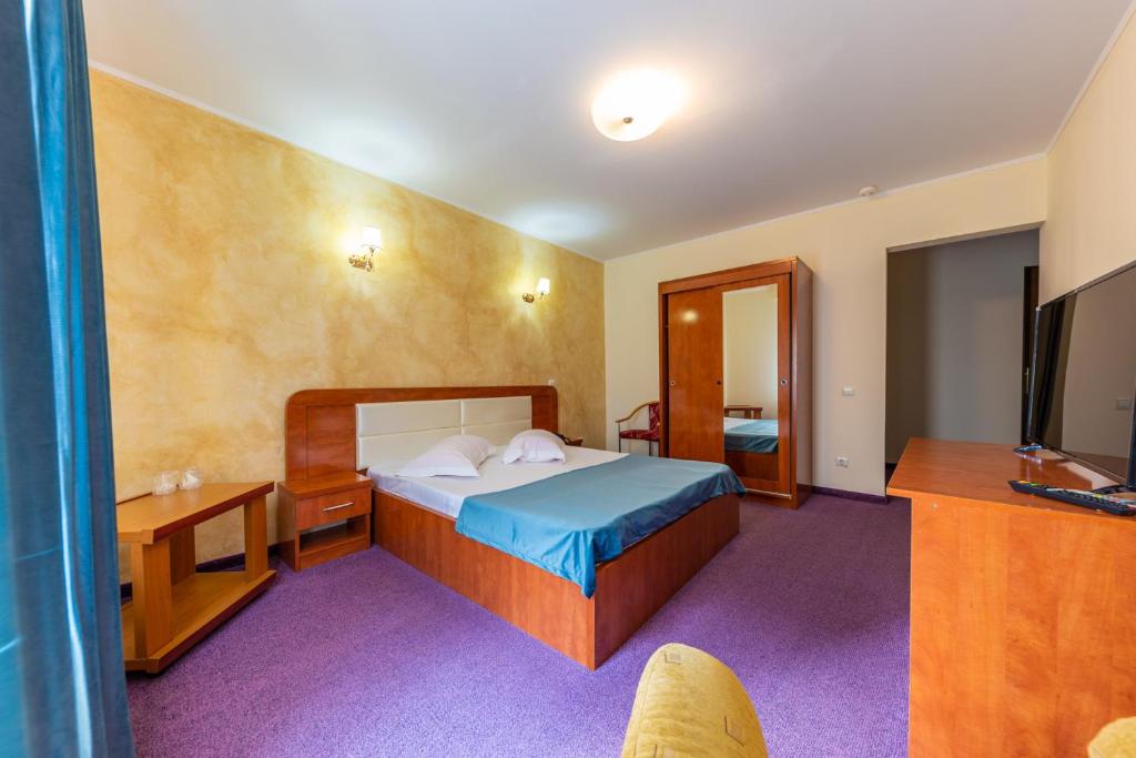 Postel nebo postele na pokoji v ubytování Hotel Amphitryon