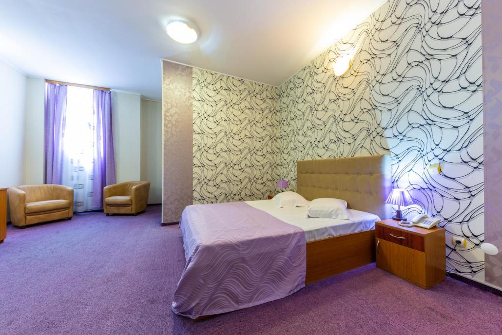 Postel nebo postele na pokoji v ubytování Hotel Amphitryon