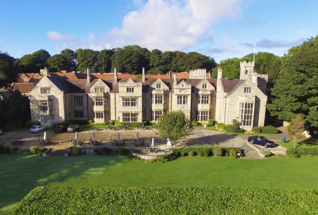 an aerial view of a large house with a yard at Redworth Hall Hotel- Part of the Cairn Collection in Newton Aycliffe