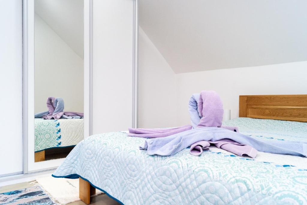 A bed or beds in a room at AllOne apartman