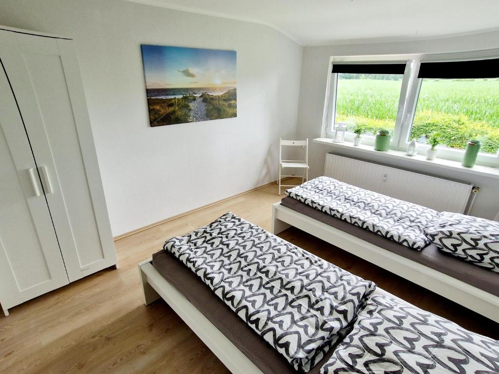a bedroom with two beds and a window at Friesenparadies FRI-Südliches Friesland in Bockhorn