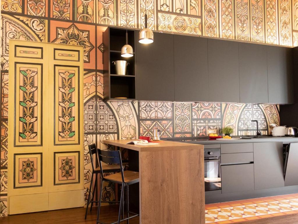 a kitchen with a counter and a table in it at The Best Rent - Elegant two-bedroom apartment close to Saint Peter's Basilica in Rome