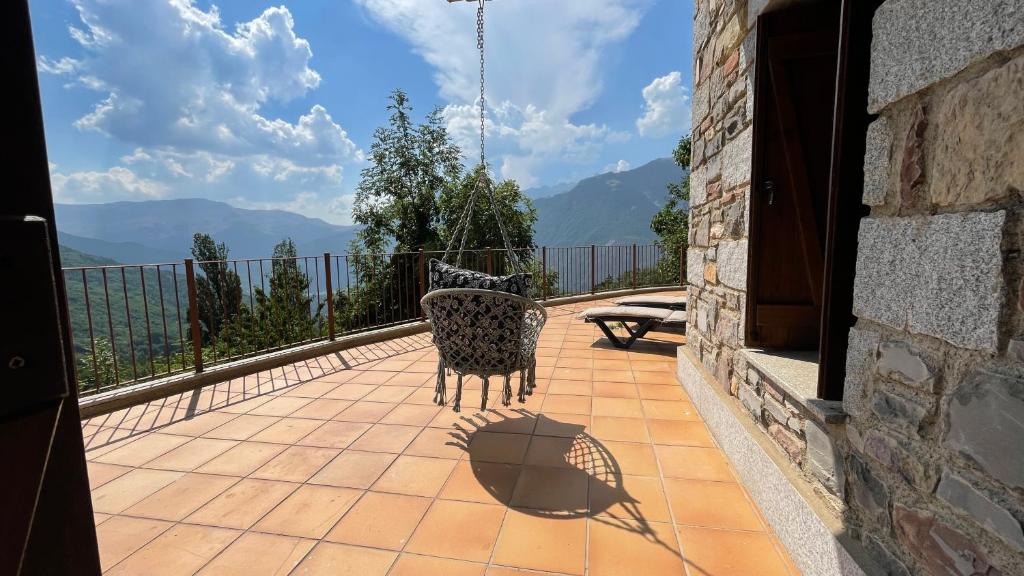 a balcony with a chair and a view of mountains at C15 - Apartamento gran terraza Aigualluts - Villmor in Cerler