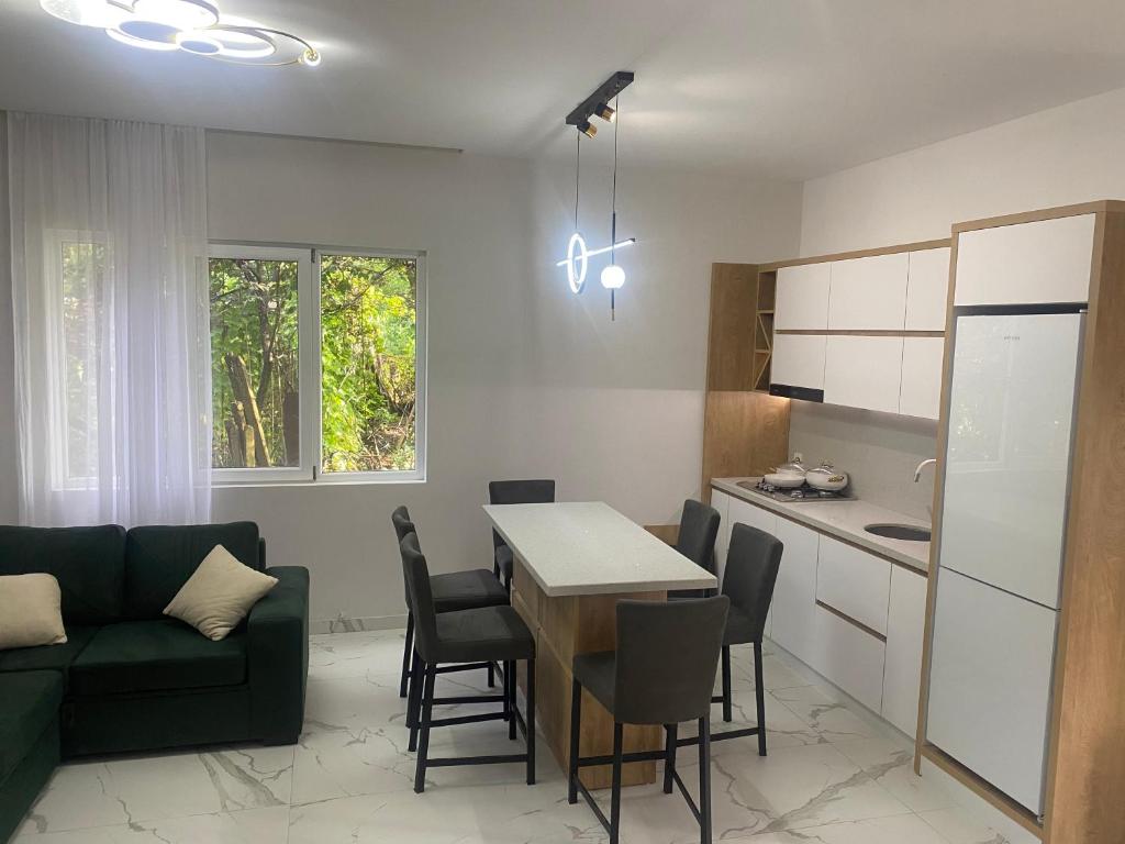 a kitchen and living room with a table and a couch at OrAnge villa in Gonio