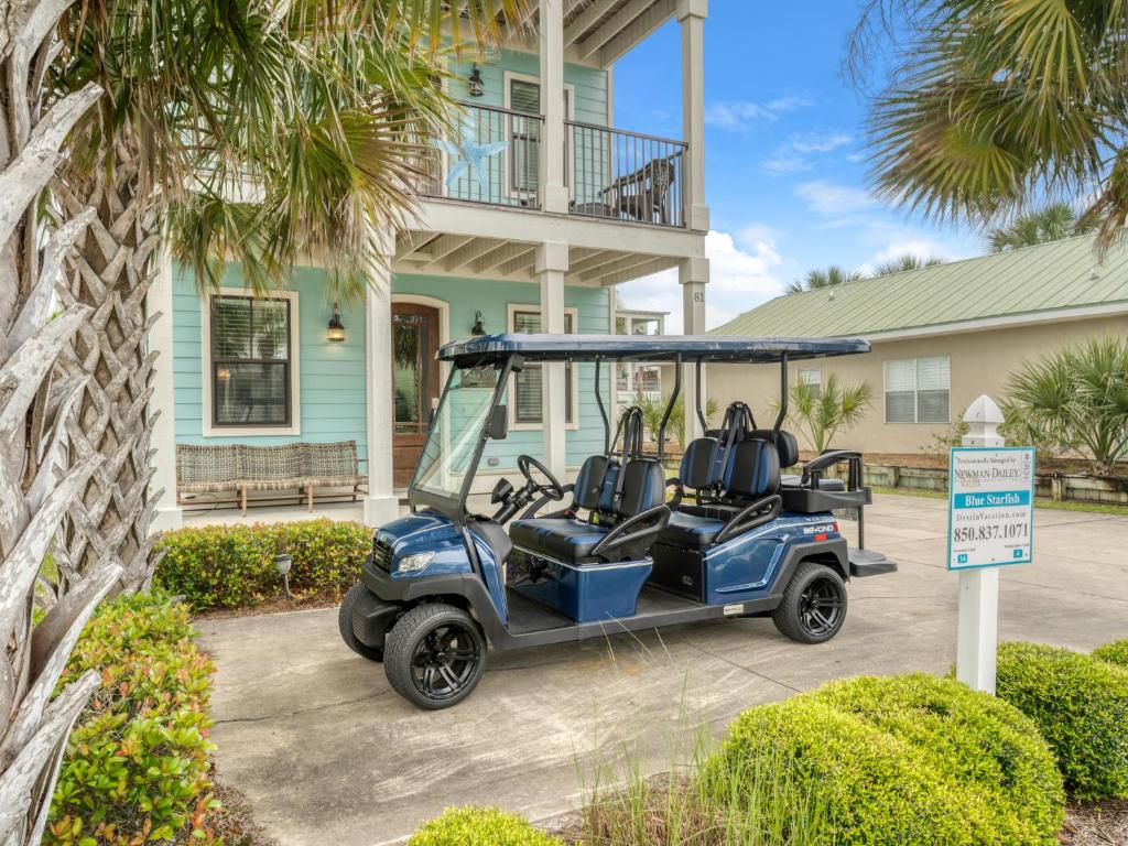 a golf cart parked in front of a house at Blue Starfish in Destin