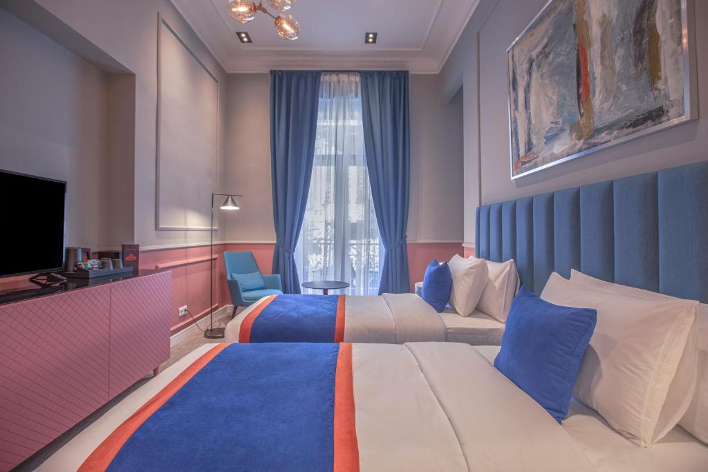 Postel nebo postele na pokoji v ubytování Heritage Hotel and Suites