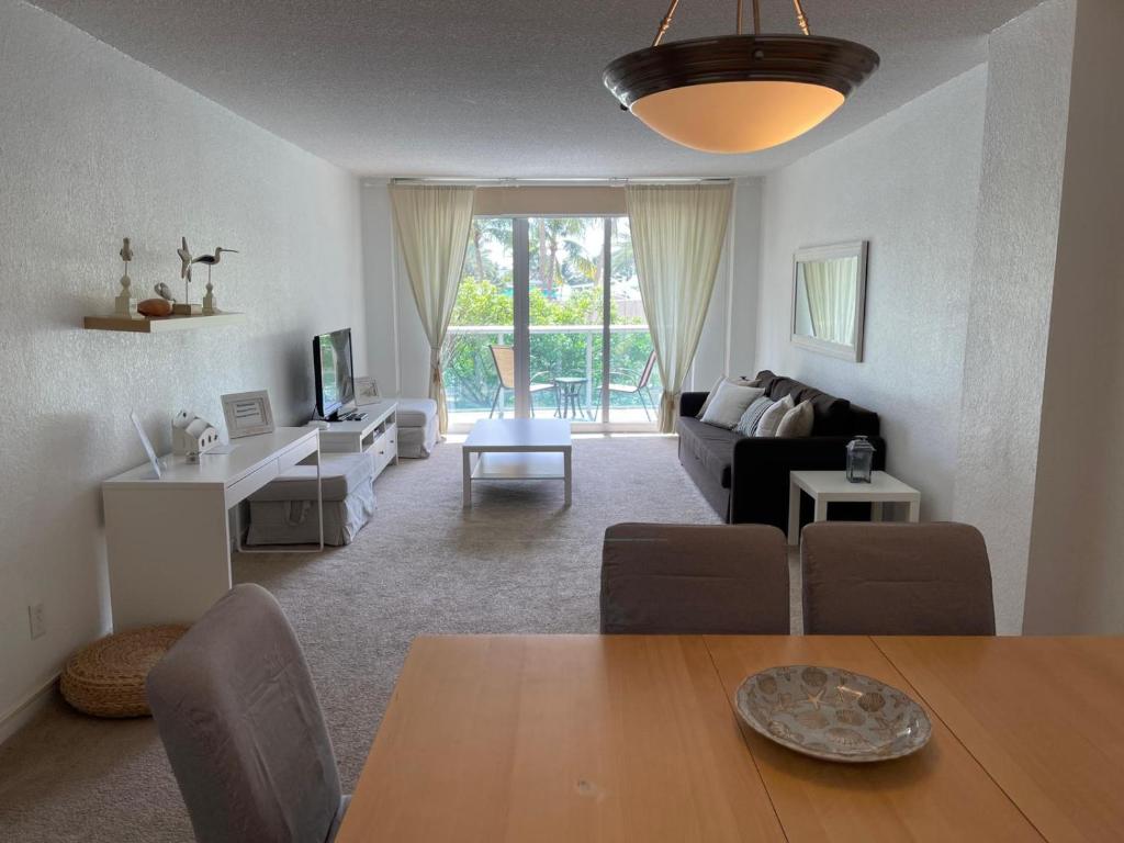 a living room with a table and a living room with a couch at Ocean Reserve 207 - STR 2270 in Miami Beach