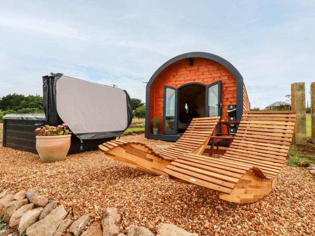 a couple of chairs sitting in front of a tiny house at Stargaze in Truro