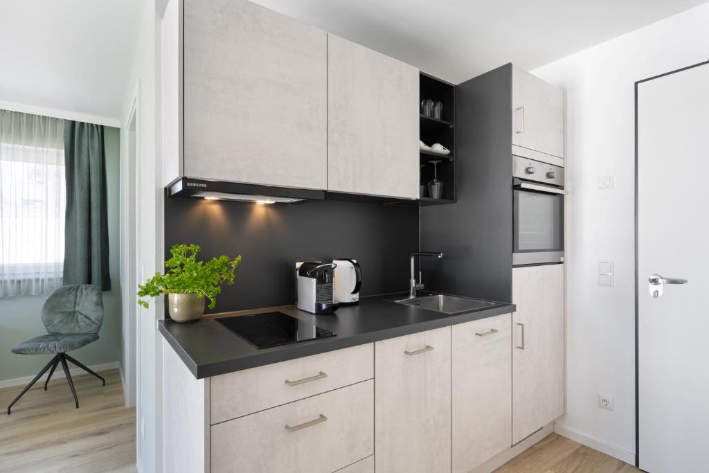 Kuchyň nebo kuchyňský kout v ubytování Snooze Apartments Alling