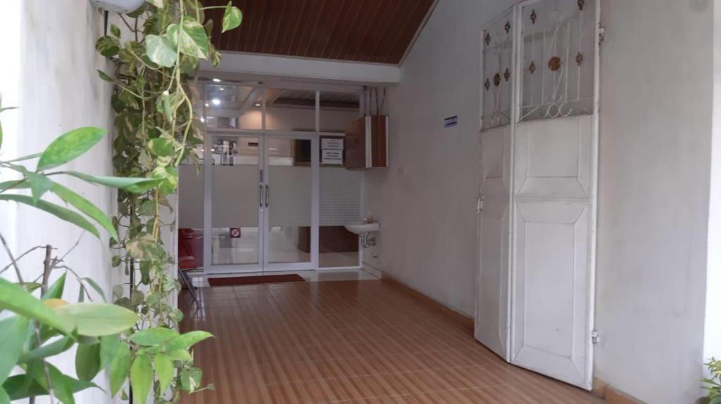 a room with a hallway with a door and a room with at House of A Syariah Sukarame in Tanjungkarang