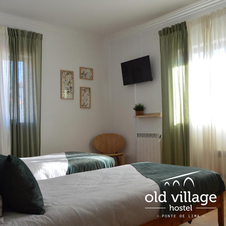 Postel nebo postele na pokoji v ubytování Old Village Hostel