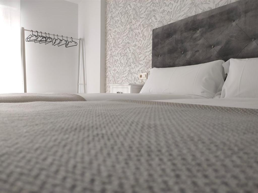 A bed or beds in a room at Second Home Arzúa apartamentos