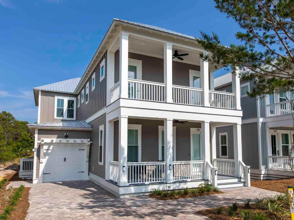 a large house with a balcony and a garage at Seabreeze - 30A by Southern Vacation Rentals in Blue Mountain Beach