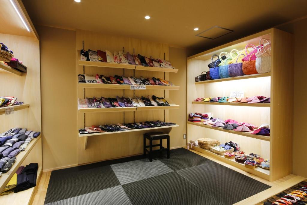 a walk in closet with lots of shoes on shelves at Yuraku Kinosaki Spa & Gardens in Toyooka