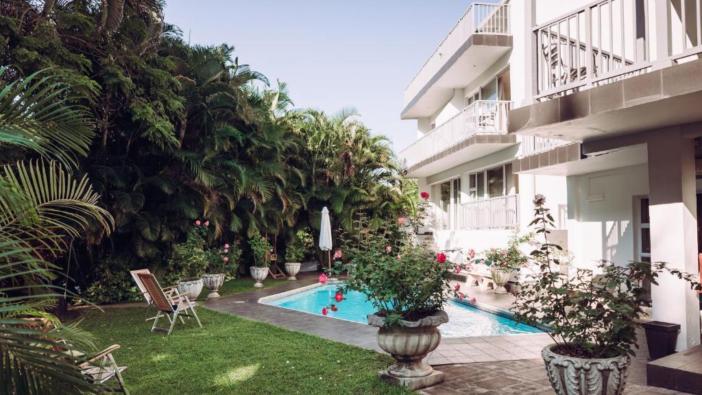 a courtyard with a swimming pool in a building at Beside Still Waters Boutique Hotel in Durban