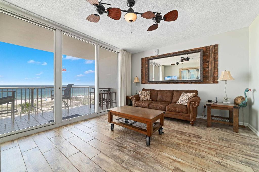 a living room with a couch and a view of the ocean at Beach Club C-509 in Gulf Highlands
