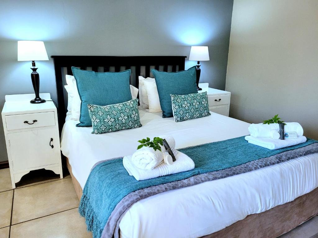 a bedroom with a bed with towels on it at Tropical Seaside Suite 14 in East London